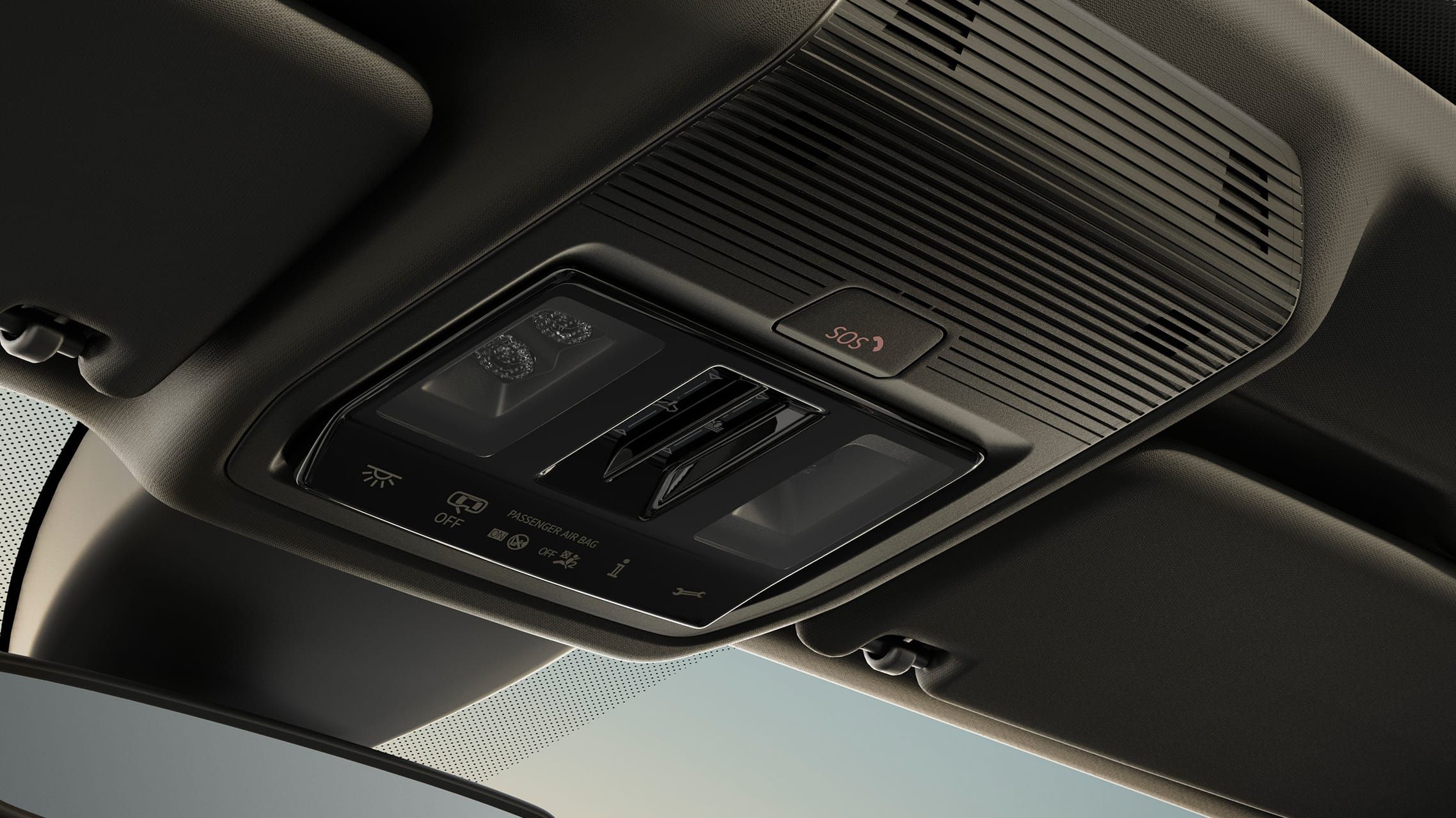 Interiér auta s pohľadom na ovládací panel v strope vozidla obsahujúci ovládacie tlačidlá.