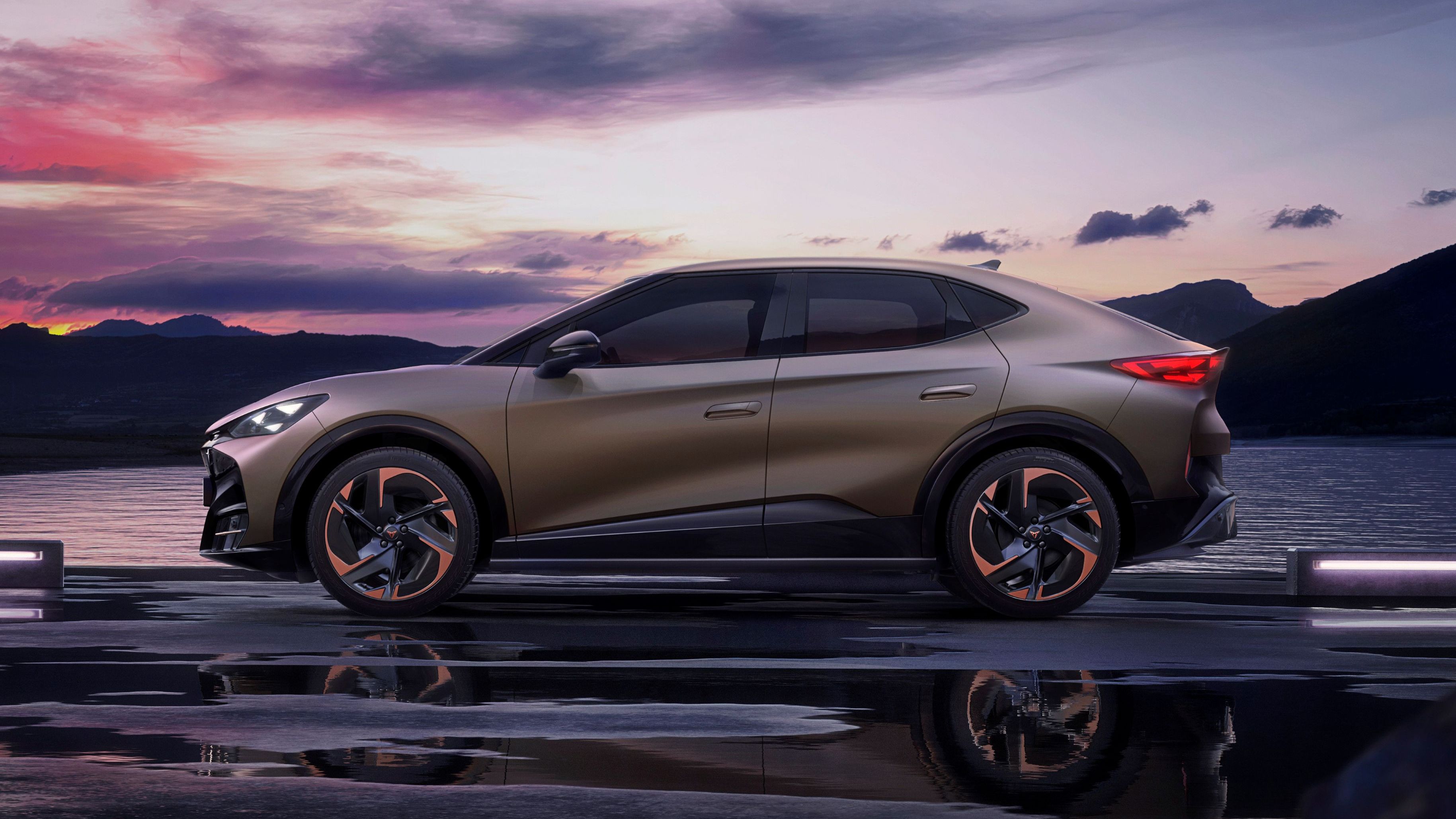 CUPRA Tavascan z bočné pohľadu zaparkovaný na ceste pri vodnej ploche v zálive. V pozadí je vidieť kopce.