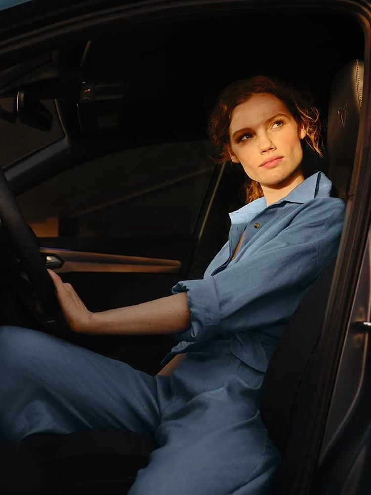 Žena sedí na sedadle vodiča vozidla CUPRA.