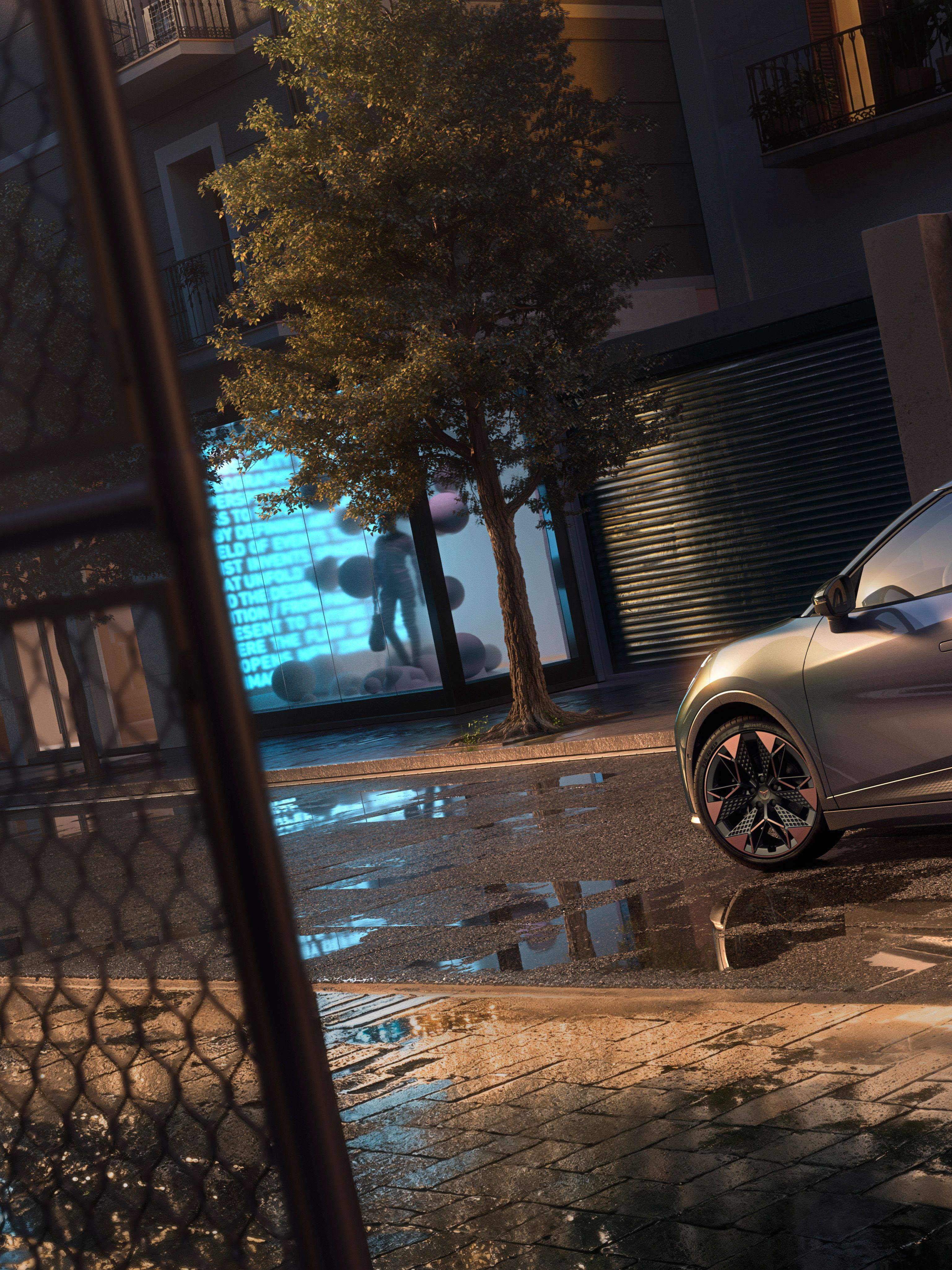 Detailný záber na zadné partie vozidla CUPRA Raval VZ v odtieni Plasma s 19-palcovými diskami, ktorý je zaparkovaný na mestskej ulici v noci.